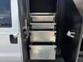 A 2016 Ford F-550 with multiple metal storage drawers visible on the side of the vehicle