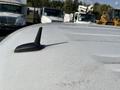 A 2014 Chevrolet Express with a black antenna mounted on the roof
