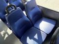 Interior view of a 2019 Chevrolet Express showing blue upholstered seats with a textured pattern and ergonomic handles