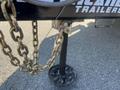 A 2024 Southland 18 Foot Dump Trailer with a metallic hitch featuring a chain attached and a black support leg on a circular base