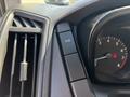 Close-up of the dashboard controls in a 2016 Ford Transit featuring a button labeled TCS OFF and an instrument gauge showing speedometer and tachometer indicators