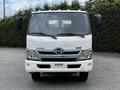 A white 2014 Hino 195 truck facing forward with a chrome badge and side mirrors on either side