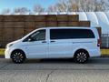 A white 2022 Mercedes-Benz Metris van with tinted windows and black alloy wheels seen from the side