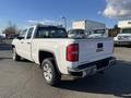 A white 2018 GMC Sierra 1500 pickup truck shown from the rear with a small bed and chrome accents on the bumper and taillights