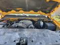 The engine compartment of a 2013 Chevrolet Silverado 1500 showcasing the engine components and surrounding machinery