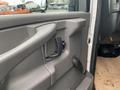 Interior door handle and panel of a 2012 Chevrolet Express with a gray finish and a black handle