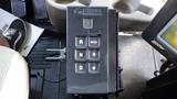 A black control panel with buttons labeled R N MODE and various symbols for an International 5600i truck