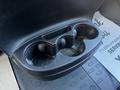 A black cup holder with three circular compartments in the center console of a 2021 RAM Promaster