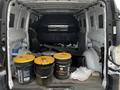 The image features the interior of a 2018 Mercedes-Benz Metris van with four black and yellow buckets on the floor and various items scattered around inside