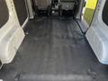 Interior view of a 2017 Nissan NV200 cargo space with a clean black rubber floor and grey upholstery on the sides