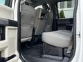 Interior view of a 2018 Ford F-450 SD showing the rear seats and floor space with gray upholstery and a folded down seatback