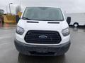 A white 2018 Ford Transit van with a black grille and distinctive Ford emblem in the center