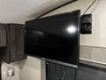 A flat-screen TV mounted on a wall inside a recreational vehicle