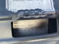 A 2005 Chevrolet Express displaying a serial number and technical specifications on a label inside the vehicle