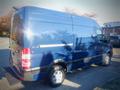 A blue 2017 Mercedes-Benz Sprinter van parked with reflective surfaces and clear side lines