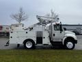 A 2013 International DuraStar bucket truck with an Altec aerial lift system on the side and storage compartments on the truck bed