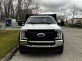 A 2019 Ford F-550 truck with a white exterior and black trim positioned head-on with a prominent front grille and chrome bumpers