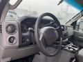 Interior view of a 2011 Ford Econoline showing the steering wheel dashboard and control panel with various gauges and a central console