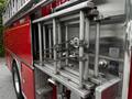 A close-up view of a 1991 Sutphen Deluge fire truck's ladder rack featuring metallic ladder supports and securing ropes