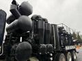 A 2018 Kenworth T800 truck with a large industrial vacuum system featuring multiple black cylindrical tanks and pipes mounted on the rear section of the vehicle