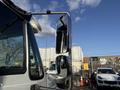 A 2017 International 4300 truck with a prominent side mirror reflecting nearby vehicles