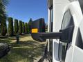 A side mirror of a 2017 Chevrolet Express van showing its black exterior and yellow marker light