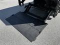 A black loading ramp extended from the rear of a 2018 Hino 195 truck designed for ease of heavy item transport and loading