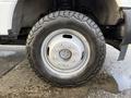 Close-up of a tire mounted on a silver wheel of a 2018 Ford F-350 with deep treads and visible brand markings on the tire sidewall
