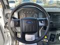Steering wheel and dashboard of a 2016 Ford F-750 showing controls speedometer and infotainment system