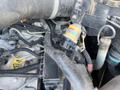 Close-up view of the engine compartment of a 2013 JCB 510-56 Loadall showing various components including pipes wires and a sensor