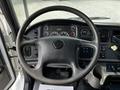 The interior view of a 2012 Freightliner M2 106 showing the steering wheel dashboard gauges and control panels