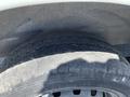 A close-up view of a tire on a 2019 Nissan NV200 showing tread pattern and sidewall details