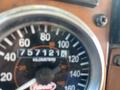 A close-up of the speedometer of a 2008 Peterbilt 340 showing a reading of 757121 kilometers