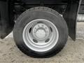 A silver wheel of a 2008 Ford F-450 SD with a black tire featuring the Continental brand logo and a detailed rim design