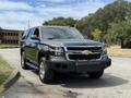 A 2017 Chevrolet Tahoe in black parked on a street with a large front grille and prominent Chevrolet logo