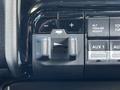 A close-up view of a control panel in a 2022 RAM 3500 featuring buttons for trailer height adjustment and auxiliary functions