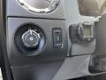 Dashboard controls of a 2016 Ford F-550 including the headlight switch and a digital gauge attached to the panel