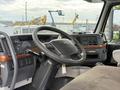 Interior view of a 2012 Volvo VNL truck featuring a steering wheel dashboard controls and a cup holder