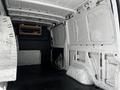 Interior view of a 2020 Mercedes-Benz Sprinter van showing the cargo space with white walls and a wooden shelf mounted on the side