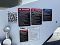 A 2006 GMC C7C00 with various warning and operation instruction labels affixed to its body