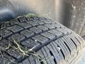 Close-up of a tire from a 2019 RAM 1500 Classic showing detailed tread pattern and some grass clippings lodged in the grooves