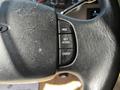 Close-up of the steering wheel of a 2000 Ford Motorhome showcasing control buttons for cruise settings such as resume set accelerate and coast