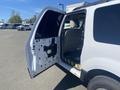 A 2013 Ford Expedition with an open passenger door displaying the interior and exposed paneling без обивки на задней стороне двери
