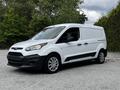 A white 2014 Ford Transit Connect van with a black grille and side accents parked at an angle