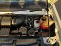 An open hood of a 2017 Ford Econoline revealing the engine compartment with various engine components visible
