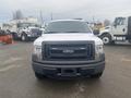 A white 2013 Ford F-150 pickup truck facing forward with a black grille and no front license plate