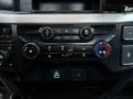 The interior dashboard panel of a 2023 Ford F-250 featuring various control knobs and buttons for audio and climate settings