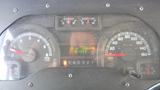 Dashboard of a 2011 Ford Econoline showing speedometer fuel gauge and other instruments including RPM and odometer readings