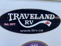 Image of a Traveland RV logo featuring the text "TRAVELAND RV Est 1977" with a Canadian flag and website URL www.tlrv.ca