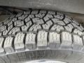 Close-up of a tire on a 2012 GMC Savana showcasing a detailed tread pattern designed for improved grip and traction